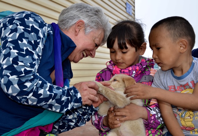 Lavrentiya children and dog with Heritage Expeditions' guest